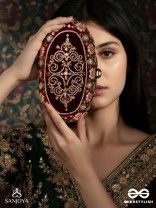 ZEVARIYA – HEIRLOOM-STYLE OVAL CLUTCH WITH INTRICATE ZARI DETAILING AND GOLDEN METAL FRAME