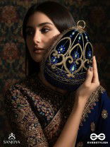 SITARAA – POLISHED OVAL ROYAL BLUE VELVET CLUTCH WITH STONE-ACCENTED HANDWORK AND GOLDEN METAL FRAME