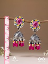 Suryaruchi-Sun's Radiance-Lavish pink earrings enamelled with a sun motif and oxidized jhumka adorned with beads and ghunghroos