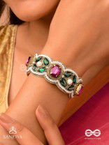 Tarangini-Wavy beauty-opulent bracelet embedded with purple and green stones