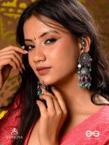 RATNA TILAKA-JEWEL ADORNMENT- EARRINGS ENAMELLED IN SHADES OF BLUE AND BLACK, ACCENTED WITH GHUNGROO BEADS AND OXIDIZED JHUMKI