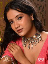  SANGRAHITAVARNA- COLLECTED HUES- ENAMELLED OXIDIZED CHOKER NECKPIECE IN PASTEL HUES WITH COWRIE SHELLS, GHUNGROOS AND MIRRORWORK