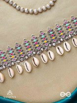 SHANKHAMALA-CONCH GARLAND- OXIDIZED NECKPIECE FEATURING PASTEL-COLOURED METALWORK, EMBELLISHED WITH DANGLING COWRIE SHELLS AND GHUNGROO'S