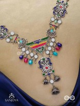 Prema raga- Love colour- Enamelled oxidized neckpiece embellished with beads, mirror and dangling jhumka.