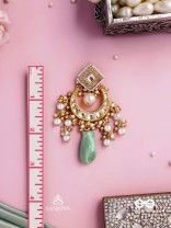 PURNIMA PHOOL – FULL MOON FLOWER AN EXQUISITE KUNDAN EARRING FEATURING GOLDEN DESIGNS, PEARL CLUSTERS, AND A GREEN GEMSTONE DROP, SYMBOLIZING ELEGANCE
