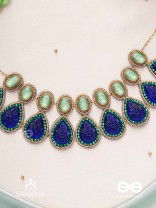 JALANEELINI - WATER LIKE BLUE ELEGANCE - BLUE TEARDROP SHAPES, GEMSTONES WITH GOLDEN EBELLISHED NECKLACE