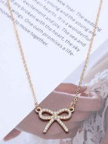 TIED IN GOLD- MINIMALIST BOW NECKPIECE