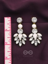 The pious touch white enigmatic stones studded earrings 
