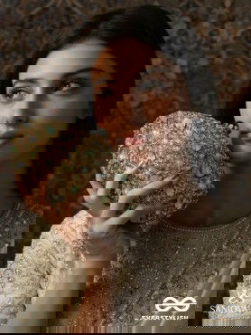 CHANDRAAYA – POLISHED OVAL GOLDEN BRONZE SILK CLUTCH WITH INTRICATE JEWEL STONE EMBELLISHMENT AND GOLDEN METAL FRAME