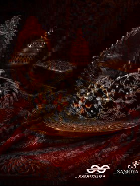 ROHINI – POLISHED BRONZE BROWN TEXTILE CLUTCH WITH FACETED JEWEL ACCENTS AND GOLDEN METAL FRAME