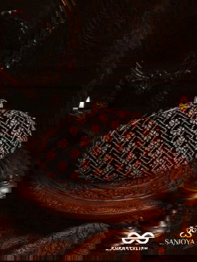 NAZRANA – CURVED MAROON SHADE TEXTILE CLUTCH WITH ORNAMENTED GRID EMBELLISHMENT AND GOLDEN METAL FRAME