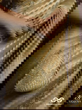 SAHIBA  – OVAL IVORY SILK CLUTCH WITH PEARL EMBEDDING AND GOLDEN METAL FRAME