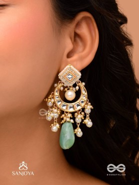 PURNIMA PHOOL – FULL MOON FLOWER AN EXQUISITE KUNDAN EARRING FEATURING GOLDEN DESIGNS, PEARL CLUSTERS, AND A GREEN GEMSTONE DROP, SYMBOLIZING ELEGANCE