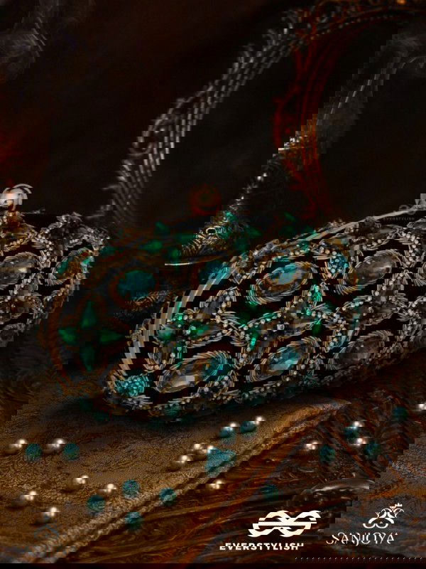 NEELZARA – OVAL DARK GREEN VELVET CLUTCH WITH INTRICATE STONE AND ZARDOZI WORK AND GOLDEN METAL FRAME