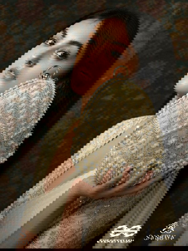 SAHIBA  – OVAL IVORY SILK CLUTCH WITH PEARL EMBEDDING AND GOLDEN METAL FRAME