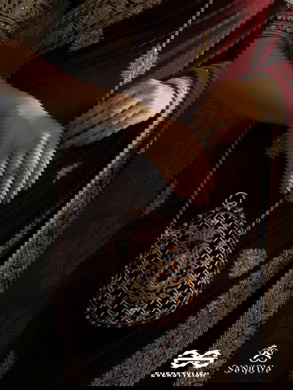 SHAHNAZ – OVAL MAROON VELVET CLUTCH WITH INTRICATE ZARDOZI EMBROIDERY AND GOLDEN METAL FRAME