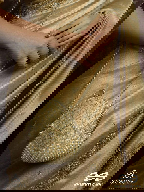 SAHIBA  – OVAL IVORY SILK CLUTCH WITH PEARL EMBEDDING AND GOLDEN METAL FRAME