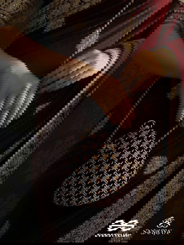 SHAHNAZ – OVAL MAROON VELVET CLUTCH WITH INTRICATE ZARDOZI EMBROIDERY AND GOLDEN METAL FRAME