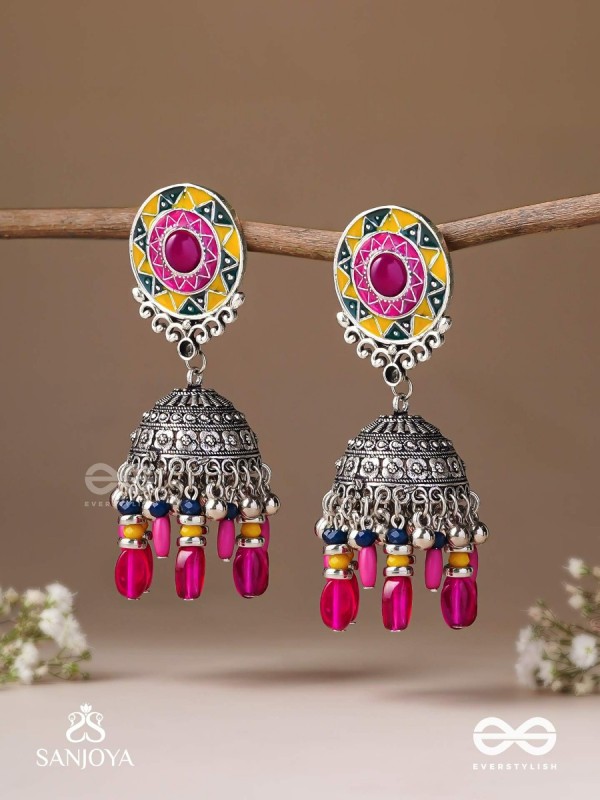 Suryaruchi-Sun's Radiance-Lavish pink earrings enamelled with a sun motif and oxidized jhumka adorned with beads and ghunghroos