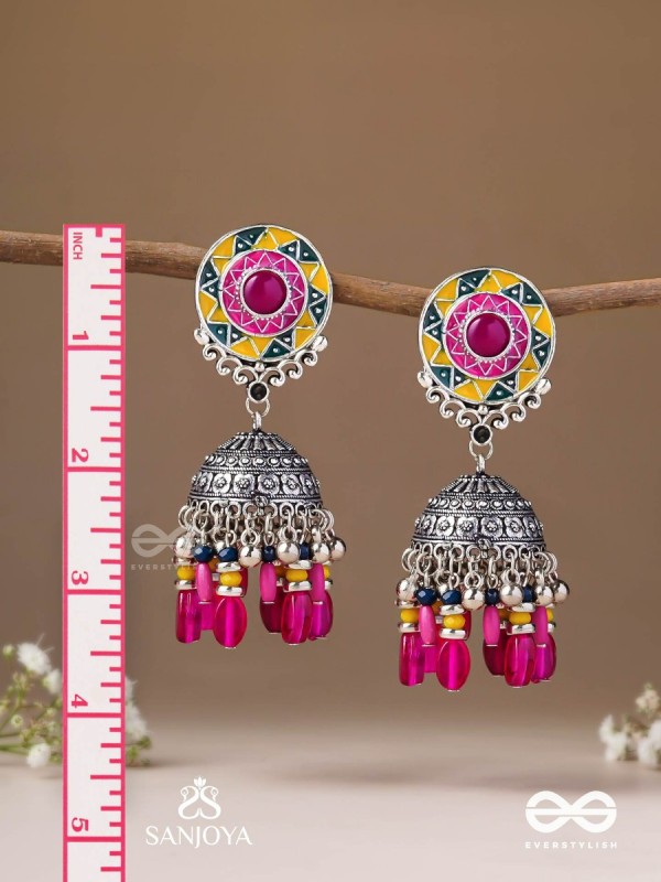 Suryaruchi-Sun's Radiance-Lavish pink earrings enamelled with a sun motif and oxidized jhumka adorned with beads and ghunghroos