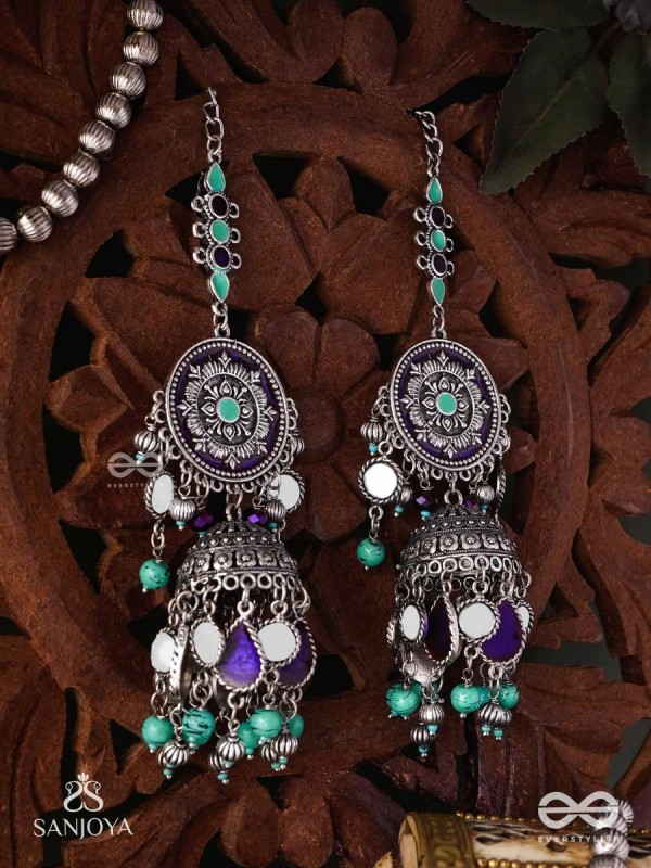 RATNA TILAKA-JEWEL ADORNMENT- EARRINGS ENAMELLED IN SHADES OF BLUE AND BLACK, ACCENTED WITH GHUNGROO BEADS AND OXIDIZED JHUMKI