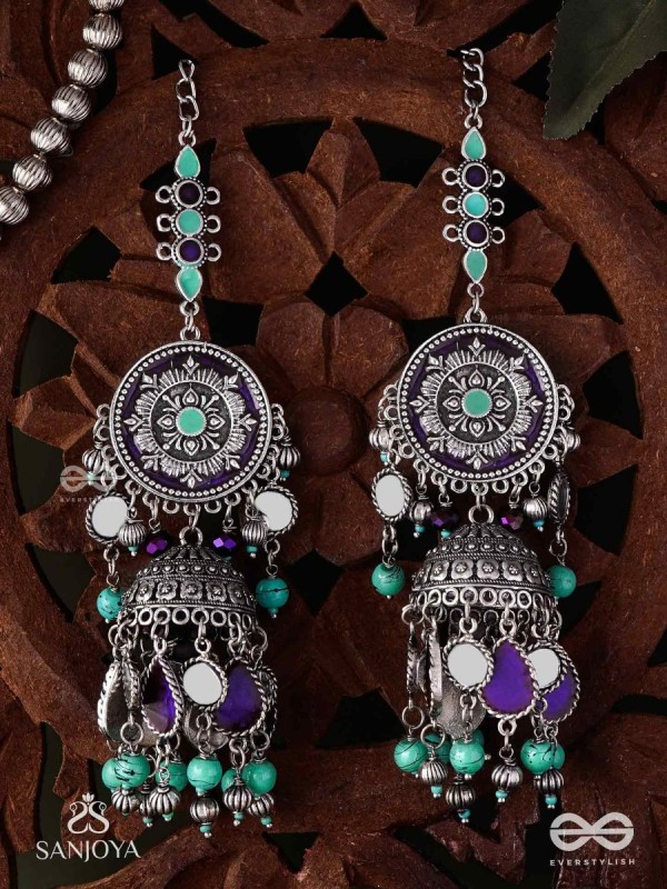 RATNA TILAKA-JEWEL ADORNMENT- EARRINGS ENAMELLED IN SHADES OF BLUE AND BLACK, ACCENTED WITH GHUNGROO BEADS AND OXIDIZED JHUMKI