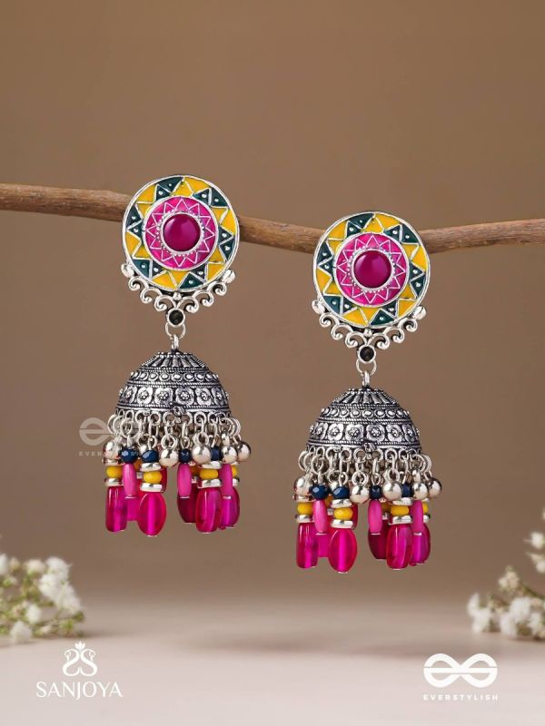 Suryaruchi-Sun's Radiance-Lavish pink earrings enamelled with a sun motif and oxidized jhumka adorned with beads and ghunghroos