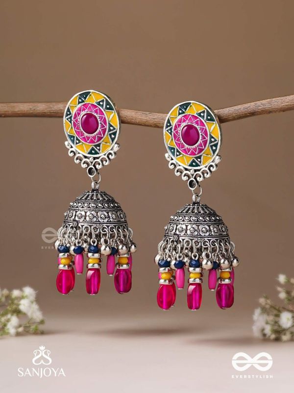 Suryaruchi-Sun's Radiance-Lavish pink earrings enamelled with a sun motif and oxidized jhumka adorned with beads and ghunghroos