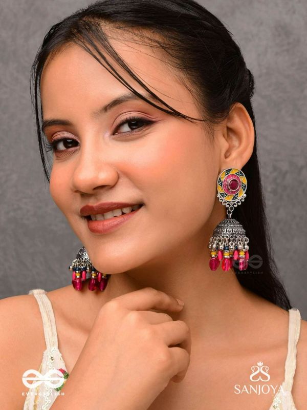 Suryaruchi-Sun's Radiance-Lavish pink earrings enamelled with a sun motif and oxidized jhumka adorned with beads and ghunghroos