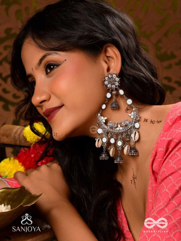 CHANDRAMAYURA- MOON-PEACOCK EARRINGS- OXIDIZED CHAANDBAALI EARRINGS, ADORNED WITH MIRRORS, GHUNGHROOS, COWRIE SHELLS, AND DANGLING JHUMKA