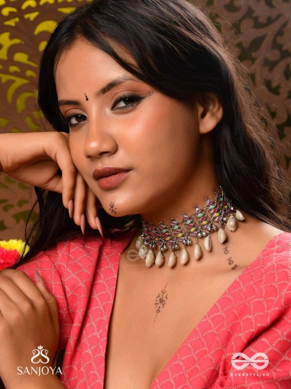 SHANKHAMALA-CONCH GARLAND- OXIDIZED NECKPIECE FEATURING PASTEL-COLOURED METALWORK, EMBELLISHED WITH DANGLING COWRIE SHELLS AND GHUNGROO'S