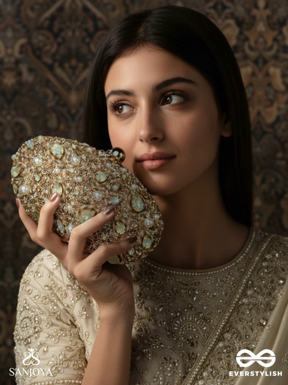 CHANDRAAYA – POLISHED OVAL GOLDEN BRONZE SILK CLUTCH WITH INTRICATE JEWEL STONE EMBELLISHMENT AND GOLDEN METAL FRAME