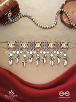  SANGRAHITAVARNA- COLLECTED HUES- ENAMELLED OXIDIZED CHOKER NECKPIECE IN PASTEL HUES WITH COWRIE SHELLS, GHUNGROOS AND MIRRORWORK