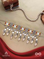 SANGRAHITAVARNA- COLLECTED HUES- ENAMELLED OXIDIZED CHOKER NECKPIECE IN PASTEL HUES WITH COWRIE SHELLS, GHUNGROOS AND MIRRORWORK