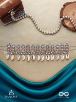 SHANKHAMALA-CONCH GARLAND- OXIDIZED NECKPIECE FEATURING PASTEL-COLOURED METALWORK, EMBELLISHED WITH DANGLING COWRIE SHELLS AND GHUNGROO'S