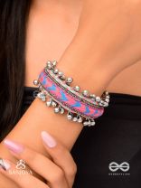 CHITRA DHARA – FLOW OF COLORS   EMBROIDERED BRACELET WITH A MIX OF COLORS AND INTRICATE THREAD WORK, ADORNED WITH GHUNGROO'S