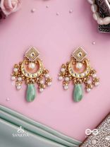 PURNIMA PHOOL – FULL MOON FLOWER AN EXQUISITE KUNDAN EARRING FEATURING GOLDEN DESIGNS, PEARL CLUSTERS, AND A GREEN GEMSTONE DROP, SYMBOLIZING ELEGANCE