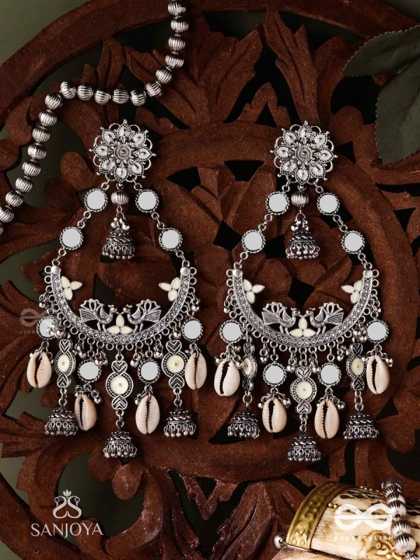 CHANDRAMAYURA- MOON-PEACOCK EARRINGS- OXIDIZED CHAANDBAALI EARRINGS, ADORNED WITH MIRRORS, GHUNGHROOS, COWRIE SHELLS, AND DANGLING JHUMKA