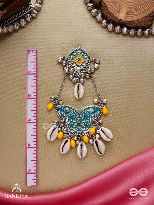 SHANKHA PUSHPA- CONCH BLOSSOM-OXIDIZED EARRINGS WITH PASTEL-HUED METALWORK, EMBELLISHED WITH DELICATE COWRIE SHELLS, YELLOW BEADS AND GHUNGROO