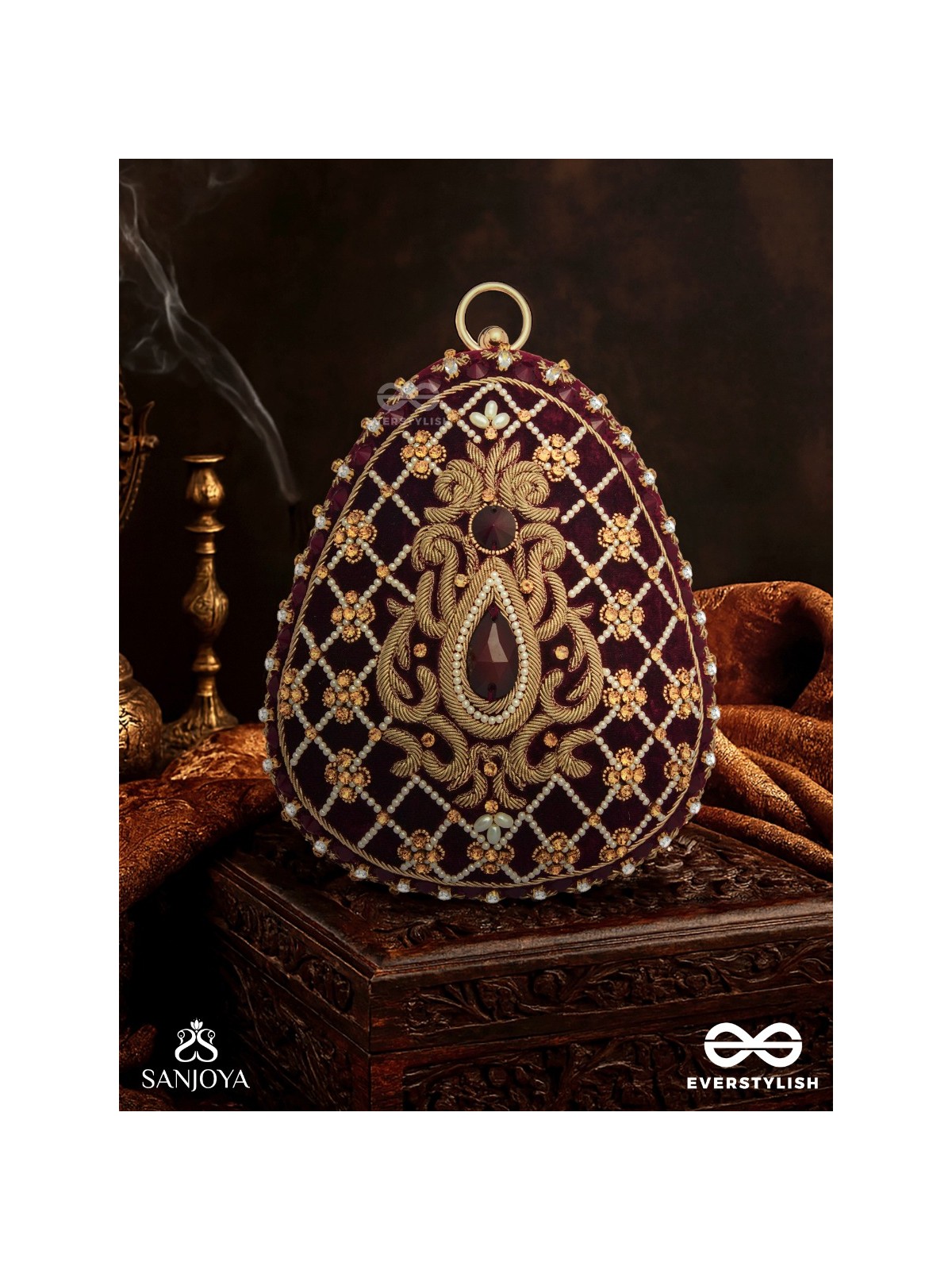 SHAHNAZ – OVAL MAROON VELVET CLUTCH WITH INTRICATE ZARDOZI EMBROIDERY AND GOLDEN METAL FRAME