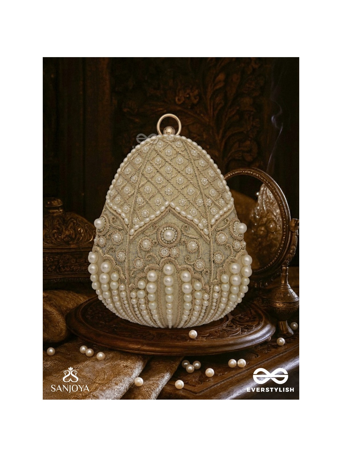 SAHIBA  – OVAL IVORY SILK CLUTCH WITH PEARL EMBEDDING AND GOLDEN METAL FRAME