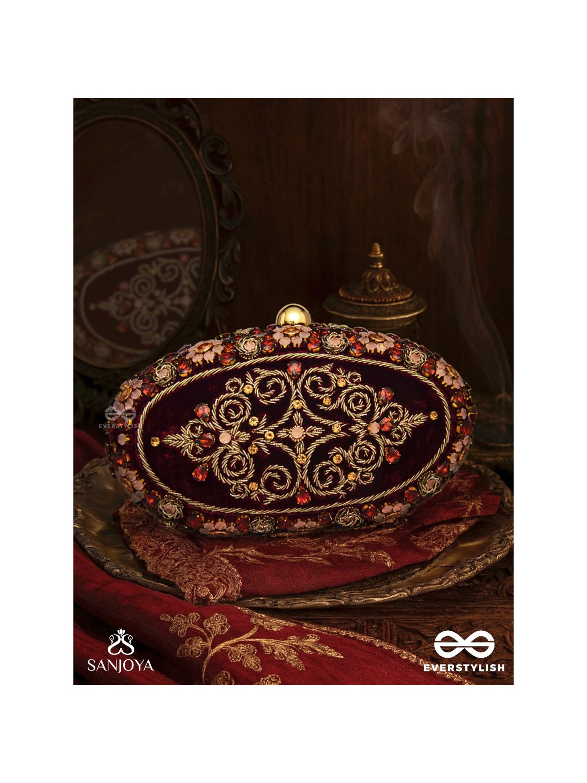 ZEVARIYA – HEIRLOOM-STYLE OVAL CLUTCH WITH INTRICATE ZARI DETAILING AND GOLDEN METAL FRAME