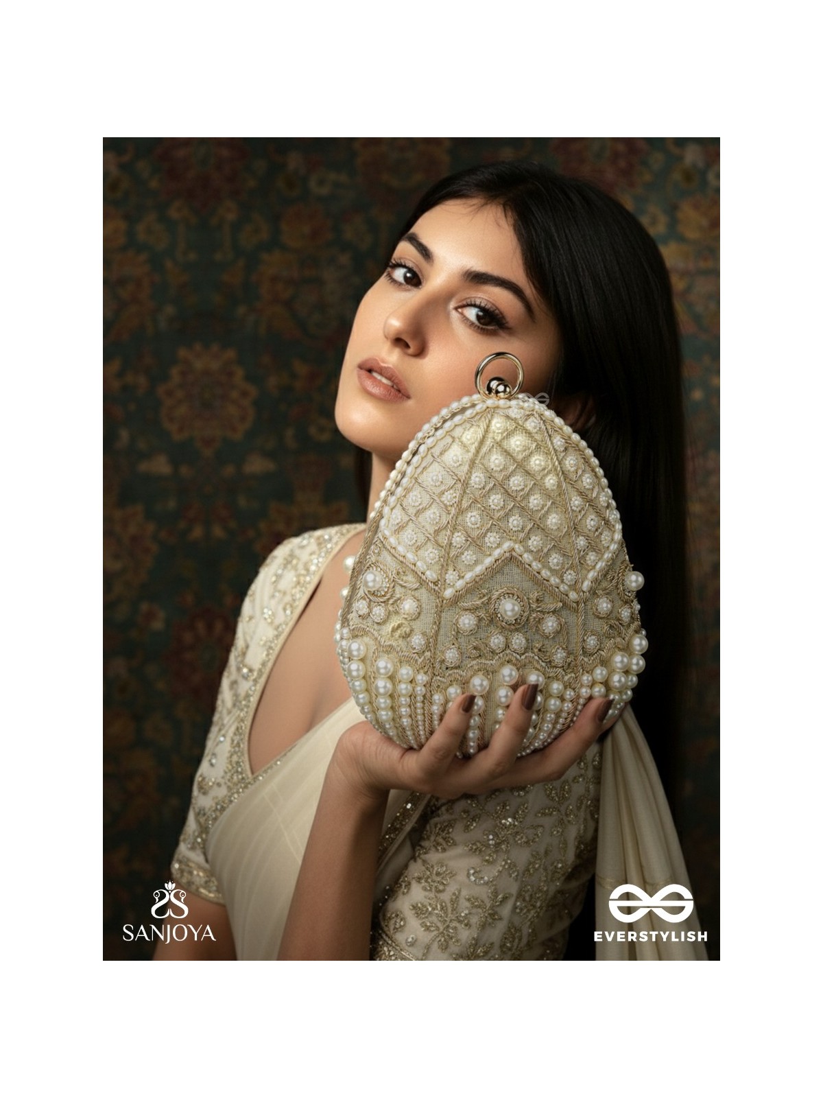 SAHIBA  – OVAL IVORY SILK CLUTCH WITH PEARL EMBEDDING AND GOLDEN METAL FRAME