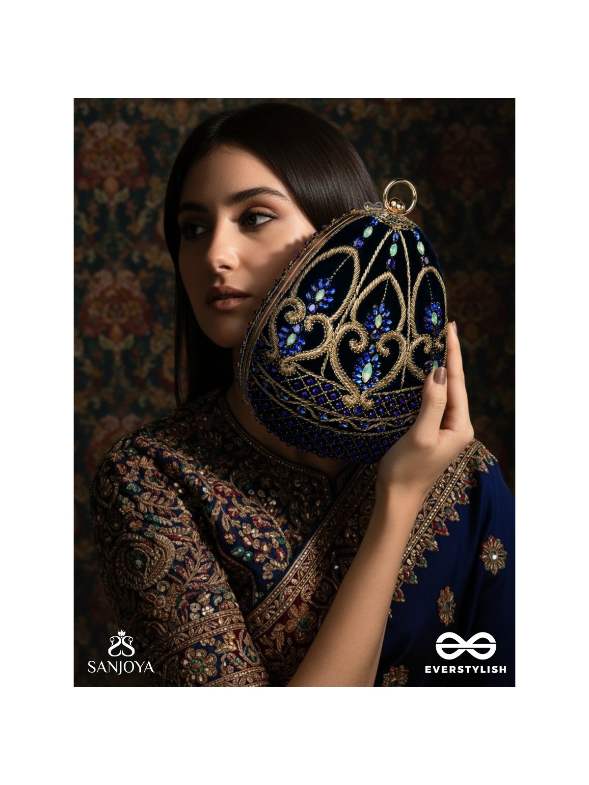 SITARAA – POLISHED OVAL ROYAL BLUE VELVET CLUTCH WITH STONE-ACCENTED HANDWORK AND GOLDEN METAL FRAME
