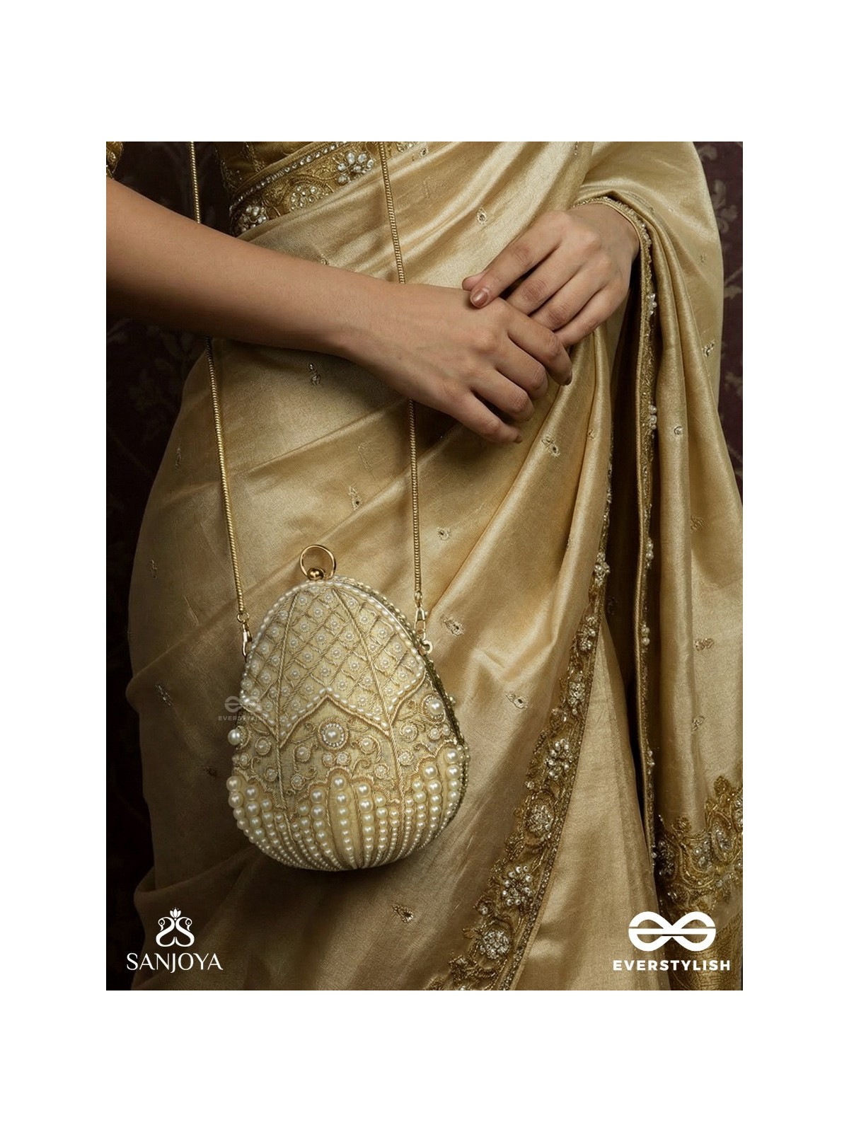 SAHIBA  – OVAL IVORY SILK CLUTCH WITH PEARL EMBEDDING AND GOLDEN METAL FRAME