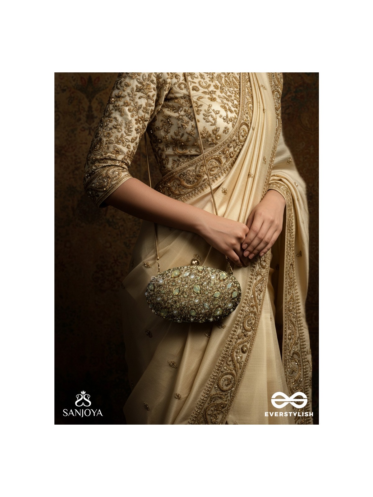 CHANDRAAYA – POLISHED OVAL GOLDEN BRONZE SILK CLUTCH WITH INTRICATE JEWEL STONE EMBELLISHMENT AND GOLDEN METAL FRAME