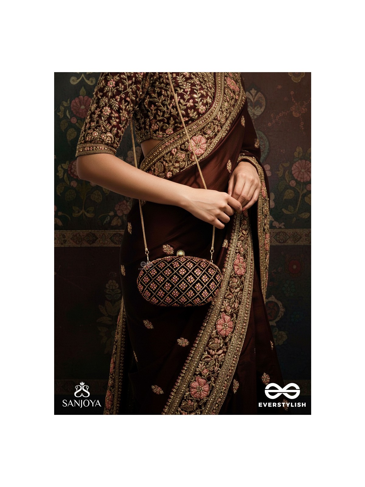 NAZRANA – CURVED MAROON SHADE TEXTILE CLUTCH WITH ORNAMENTED GRID EMBELLISHMENT AND GOLDEN METAL FRAME