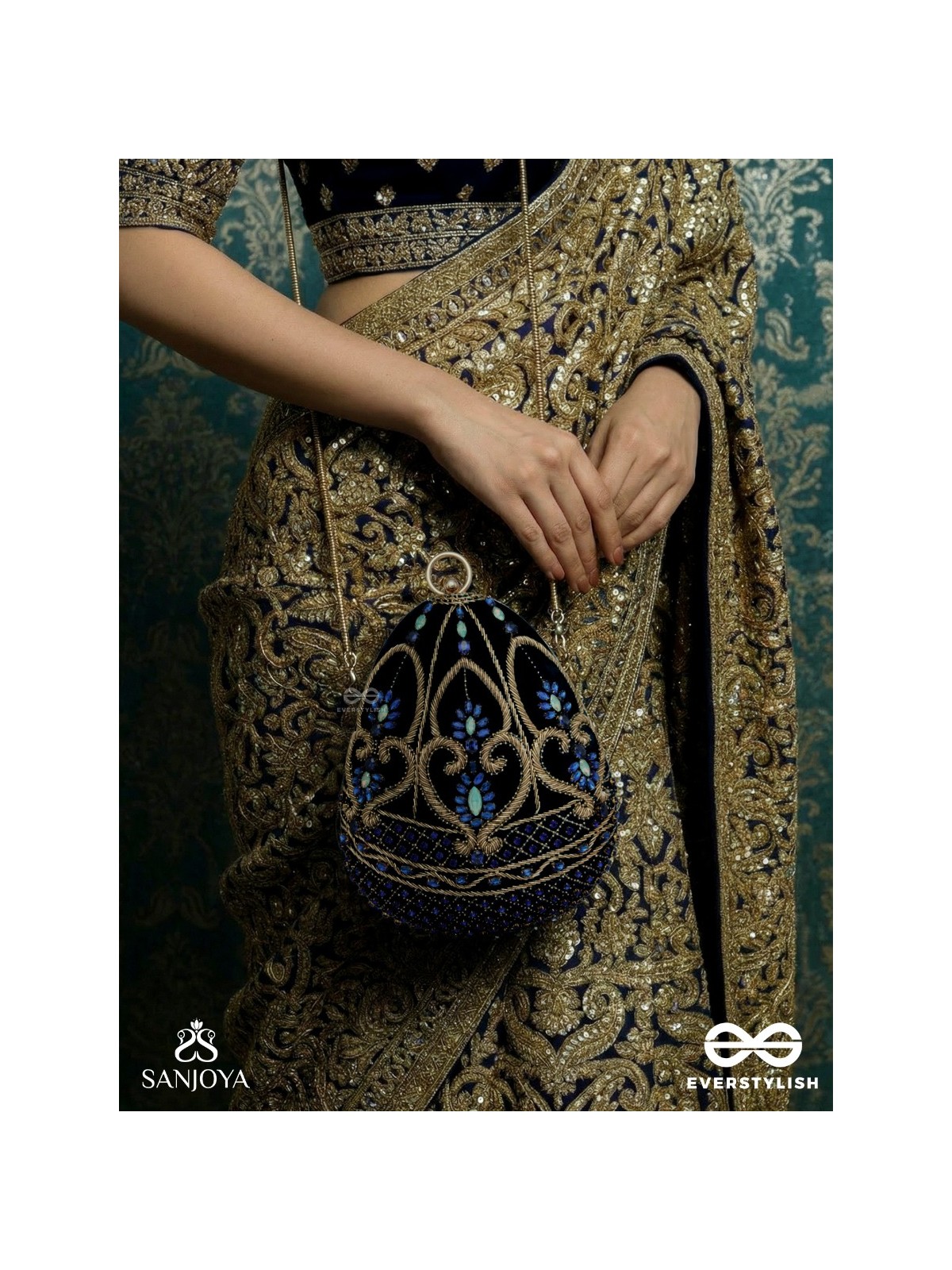 SITARAA – POLISHED OVAL ROYAL BLUE VELVET CLUTCH WITH STONE-ACCENTED HANDWORK AND GOLDEN METAL FRAME