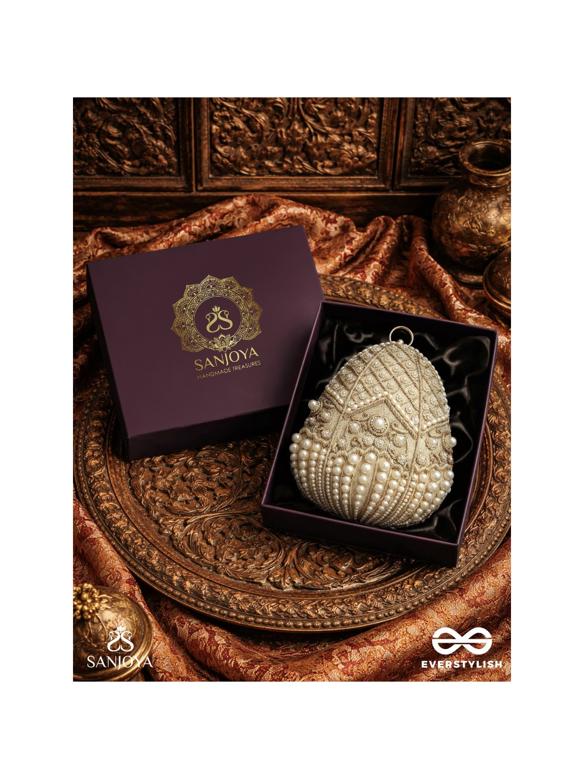 SAHIBA  – OVAL IVORY SILK CLUTCH WITH PEARL EMBEDDING AND GOLDEN METAL FRAME