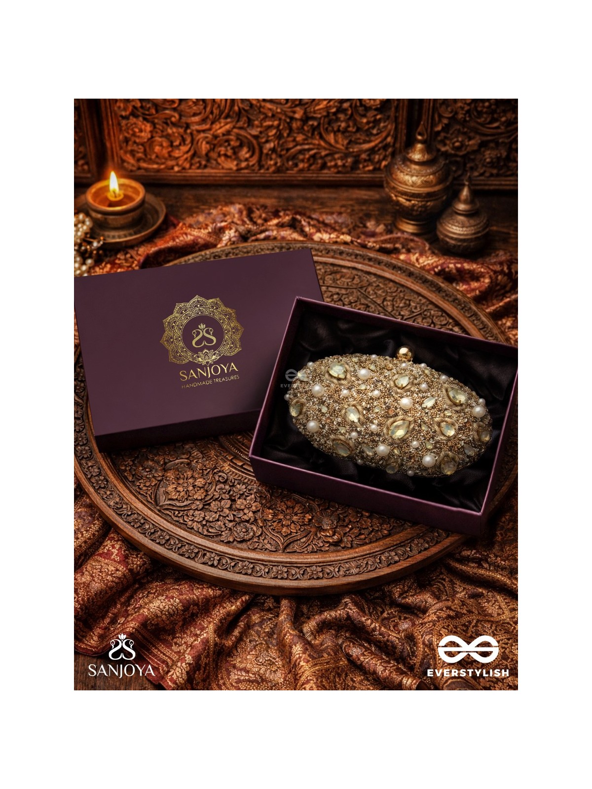 CHANDRAAYA – POLISHED OVAL GOLDEN BRONZE SILK CLUTCH WITH INTRICATE JEWEL STONE EMBELLISHMENT AND GOLDEN METAL FRAME